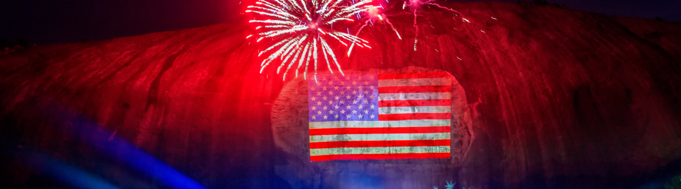 Fireworks and American Flag image projected on the mountain 